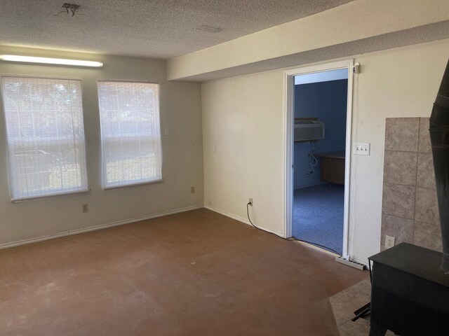 unfurnished room featuring a textured ceiling and carpet