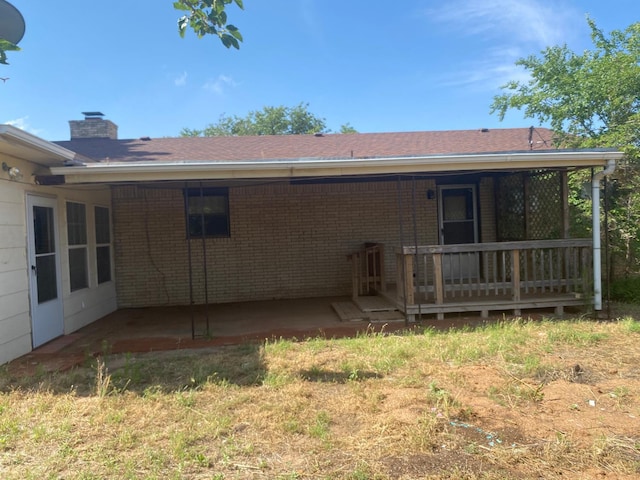 rear view of house featuring a patio area and a lawn