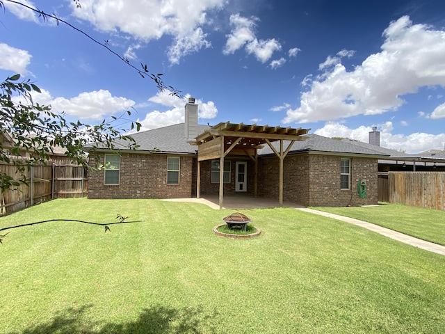 1505 Westminster Ave, Wolfforth, TX 79382 - back of house with an outdoor fire pit, a fenced backyard, a chimney, and brick siding