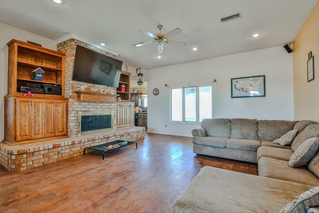 living room with ceiling fan, hardwood / wood-style floors, and a fireplace