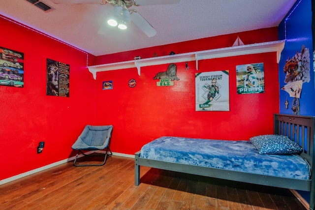 bedroom featuring hardwood / wood-style floors and ceiling fan