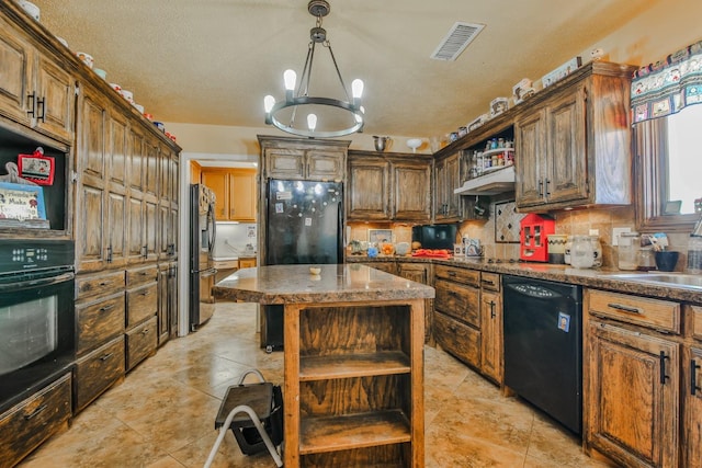 kitchen featuring light tile patterned flooring, black appliances, a chandelier, a kitchen island, and backsplash