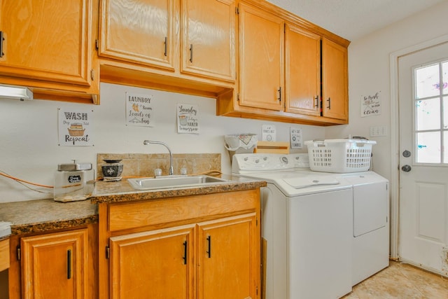 laundry area featuring cabinets, sink, and washing machine and dryer