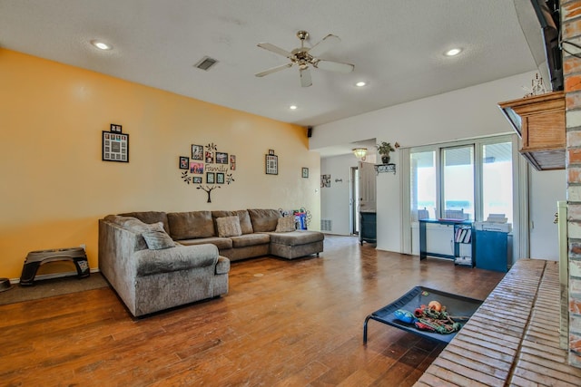 living room featuring wood-type flooring and ceiling fan