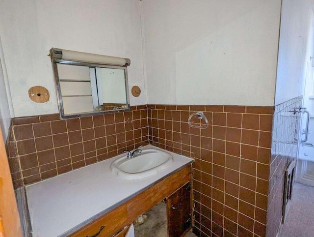 bathroom featuring sink and tile walls