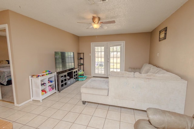 tiled living room featuring a textured ceiling and ceiling fan