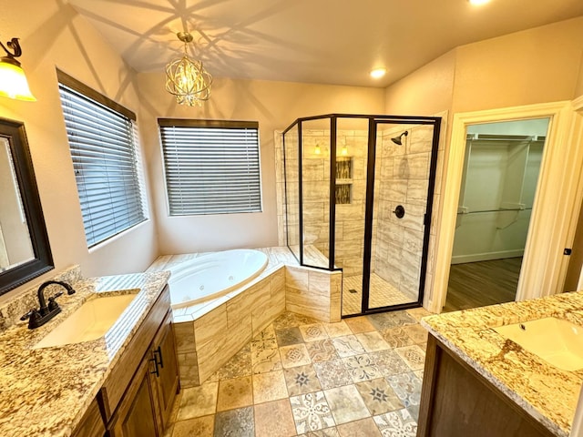 bathroom with vanity, a notable chandelier, and shower with separate bathtub