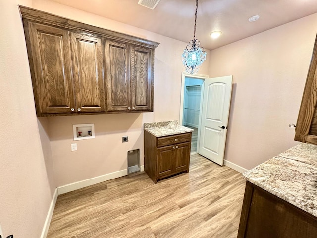 laundry room featuring washer hookup, light wood-type flooring, cabinets, and hookup for an electric dryer