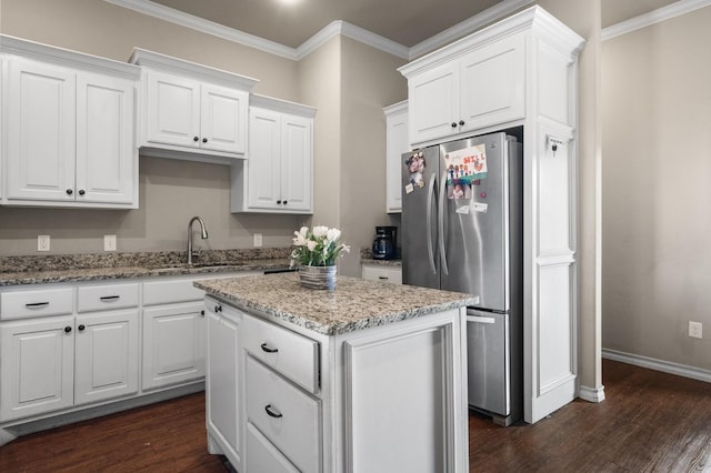 kitchen featuring white cabinetry, sink, and stainless steel fridge