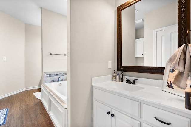 bathroom with vanity, a bathtub, and wood-type flooring