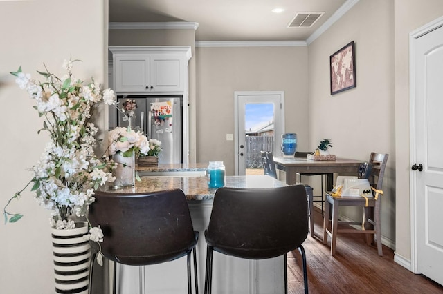 dining room featuring crown molding and dark hardwood / wood-style flooring