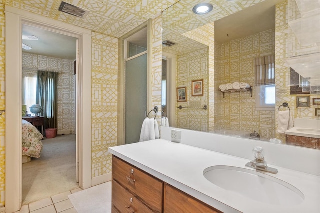 bathroom featuring vanity, visible vents, wallpapered walls, an enclosed shower, and ensuite bathroom