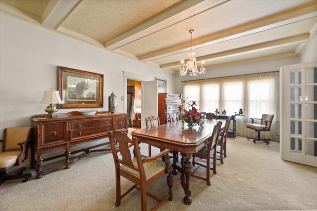 dining room with beam ceiling, a notable chandelier, and light colored carpet