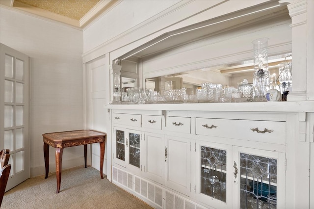 bar featuring light colored carpet and crown molding
