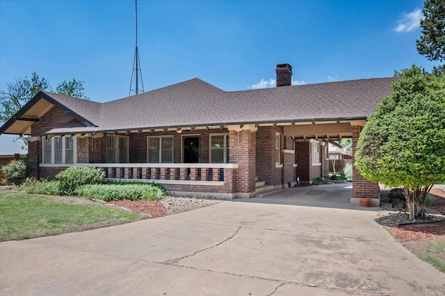 ranch-style house with brick siding, a chimney, driveway, and a shingled roof