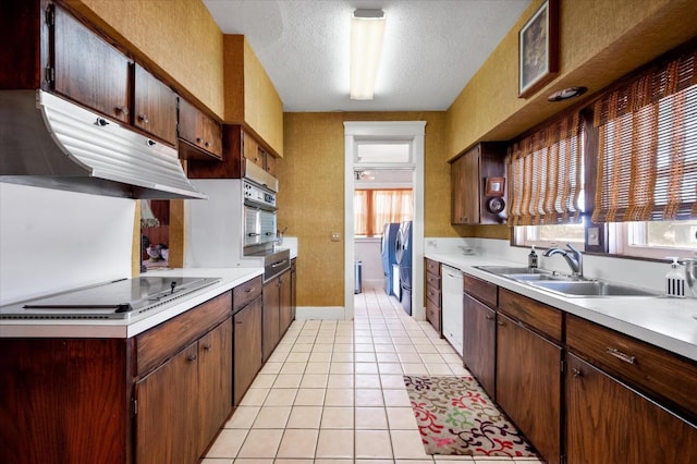 kitchen with light tile patterned floors, white dishwasher, oven, a sink, and black electric cooktop