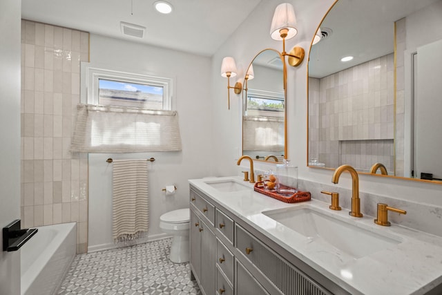 bathroom featuring visible vents, a sink, and a healthy amount of sunlight