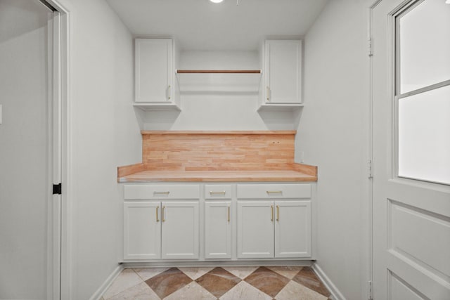 laundry area with baseboards