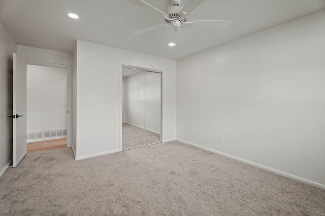unfurnished bedroom with baseboards, carpet floors, visible vents, and a closet