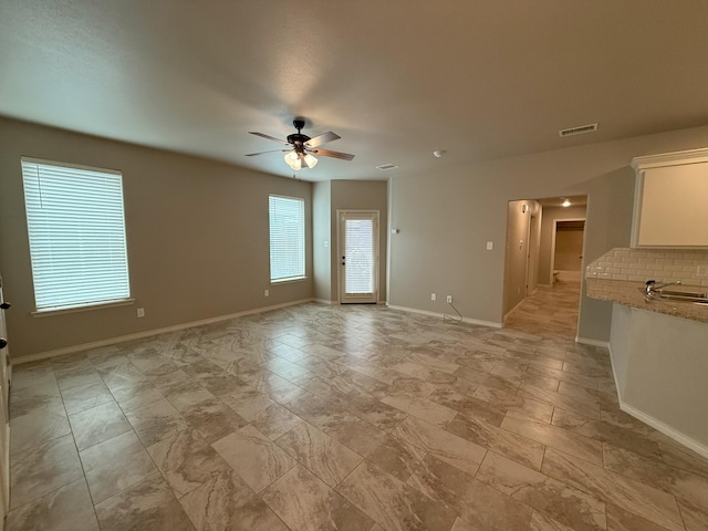 unfurnished room featuring ceiling fan