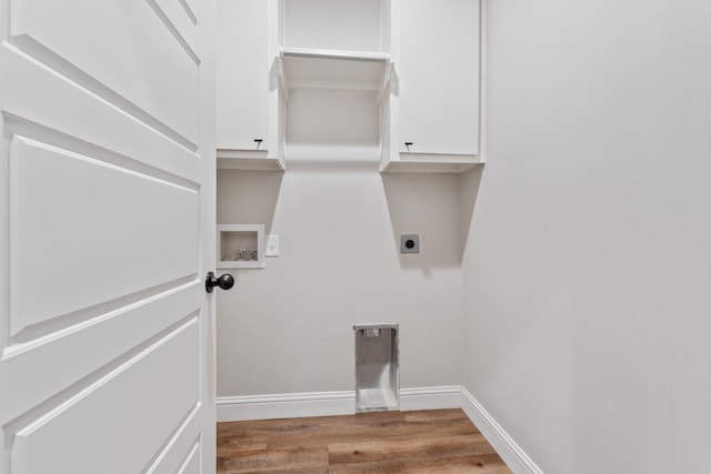 washroom featuring cabinets, hookup for a washing machine, light hardwood / wood-style floors, and hookup for an electric dryer