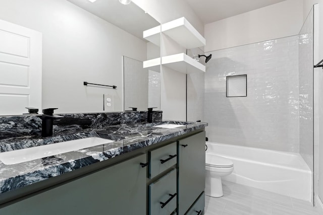 full bathroom featuring tile patterned floors, vanity, toilet, and tiled shower / bath combo