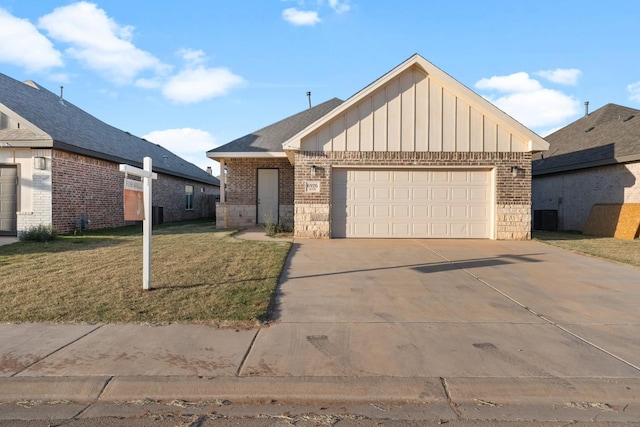 view of front of property with a garage, a front yard, and cooling unit