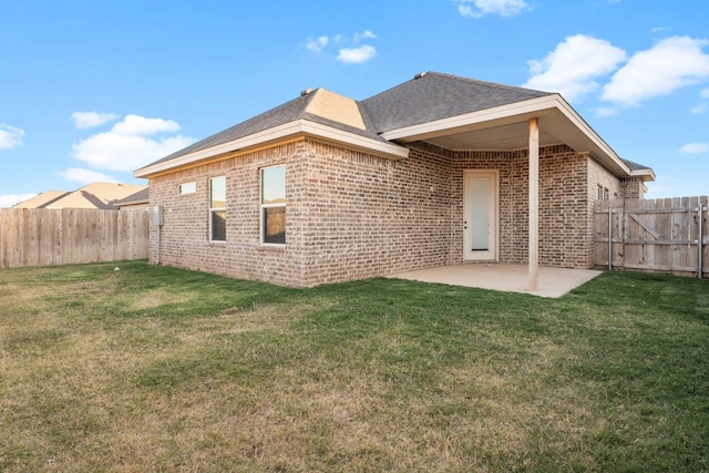 back of property with a patio area and a lawn