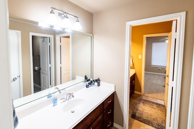 bathroom featuring baseboards and vanity