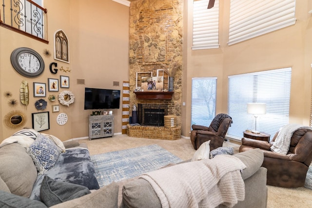 carpeted living area featuring baseboards, a high ceiling, and a fireplace