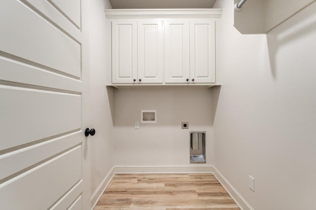 clothes washing area with electric dryer hookup, hookup for a washing machine, light hardwood / wood-style flooring, and cabinets