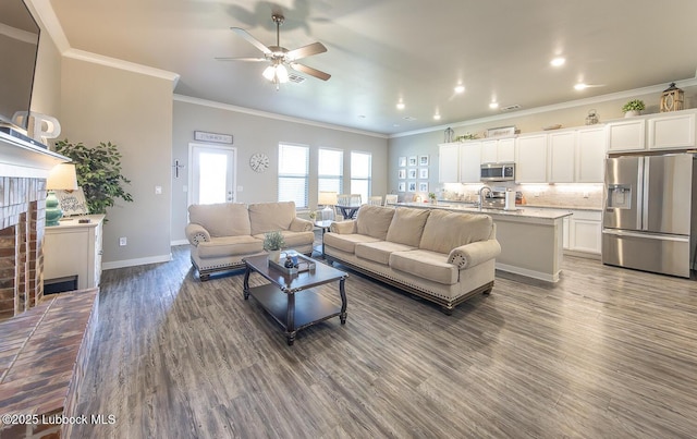 3301 Venita Ave, Lubbock, TX 79407 - living area featuring a ceiling fan, wood finished floors, crown molding, a brick fireplace, and recessed lighting