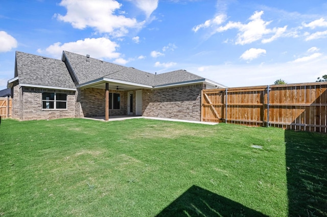 rear view of property with a patio area and a lawn