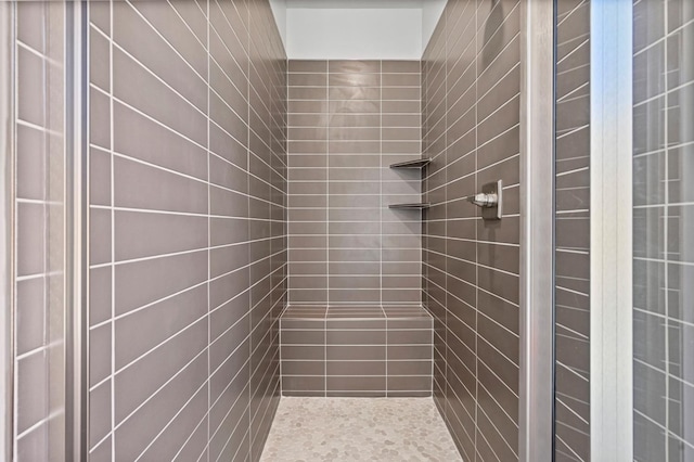 bathroom with a tile shower