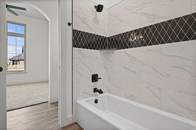 bathroom featuring hardwood / wood-style floors and tiled shower / bath combo