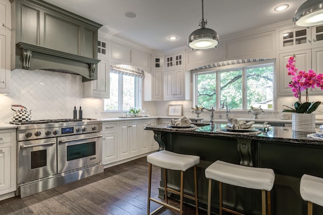 kitchen featuring range with two ovens, white cabinetry, and dark hardwood / wood-style flooring