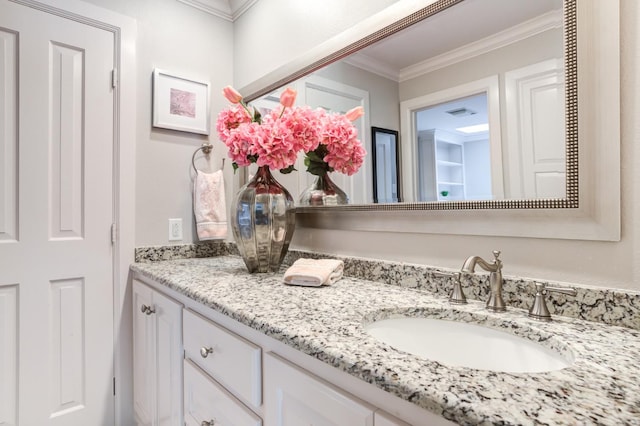 bathroom with crown molding and vanity