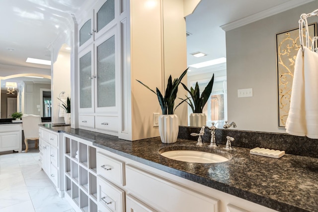 bathroom with vanity and crown molding