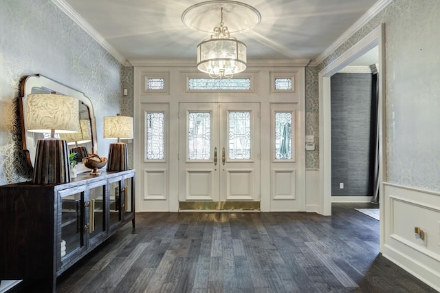 entrance foyer featuring crown molding, dark wood-type flooring, french doors, and a notable chandelier