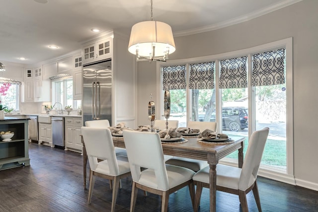 dining room featuring dark hardwood / wood-style flooring, plenty of natural light, and ornamental molding