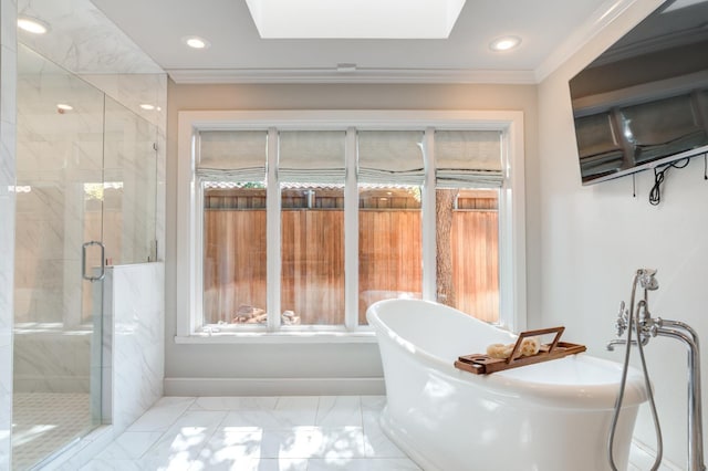 bathroom with shower with separate bathtub, ornamental molding, and a skylight