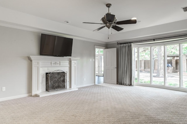 unfurnished living room featuring crown molding, carpet, and ceiling fan