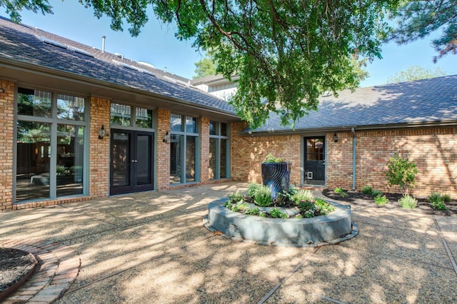 back of house with french doors and a patio