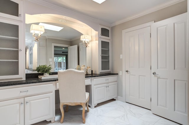 bathroom featuring vanity, ornamental molding, and a notable chandelier