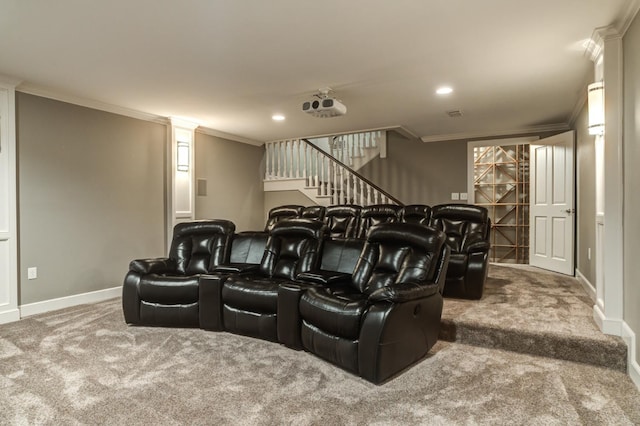 carpeted home theater featuring ornamental molding