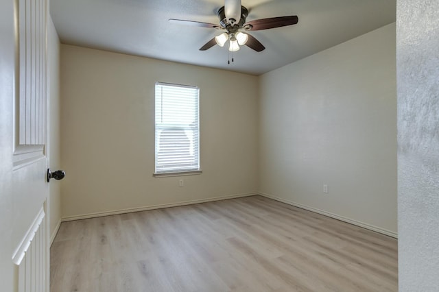 empty room with ceiling fan and light hardwood / wood-style floors