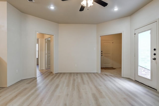 empty room with ceiling fan and light wood-type flooring