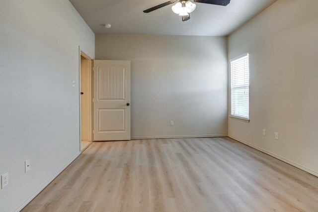 empty room with light hardwood / wood-style floors and ceiling fan