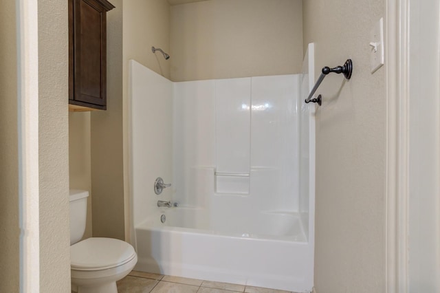 bathroom with toilet, shower / bathing tub combination, and tile patterned floors