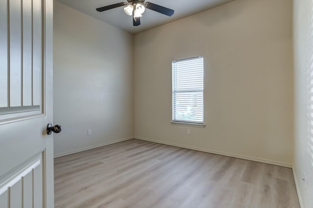 spare room featuring light wood-type flooring and ceiling fan